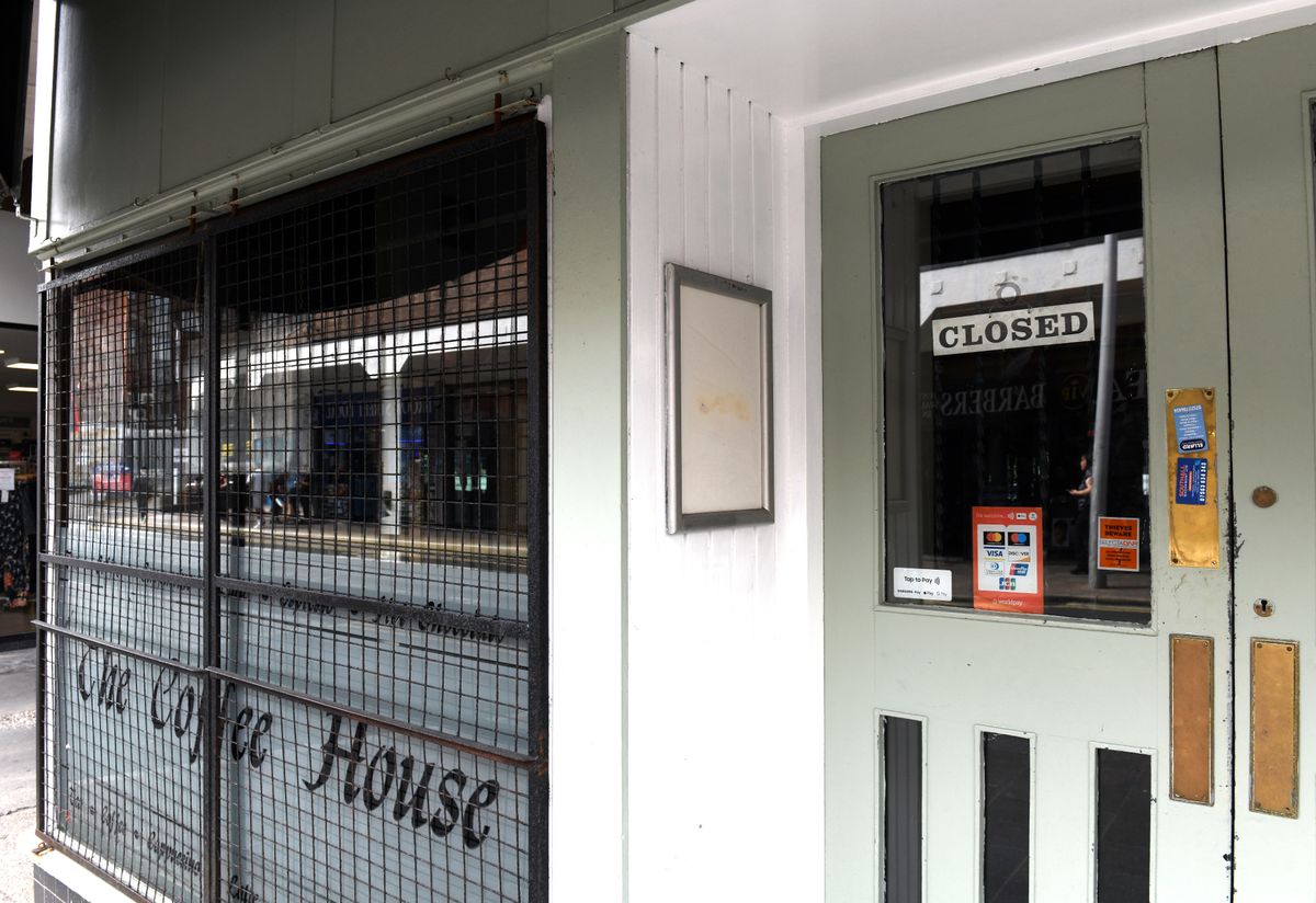 The coffee house appeared closed with shutters on the windows