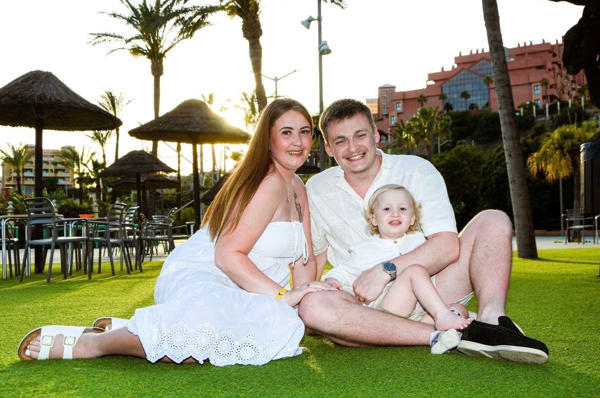 Courtney Lees, Carson Lees and Carter Lees on grassed area at a holiday resort