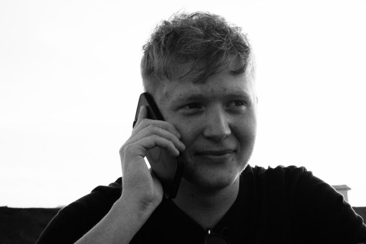 Ewan McWilliam in black and white holding a phone to his ear