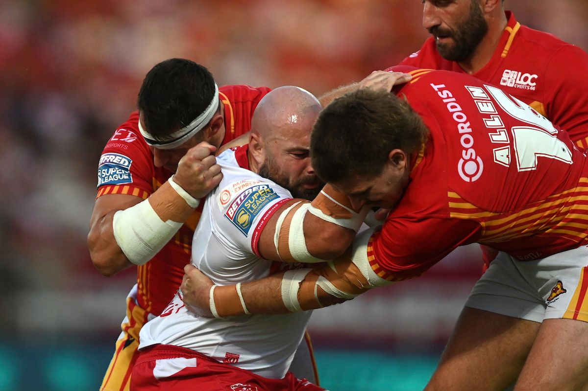 Hull KR's Sam Luckley is tackled by Catalans' Ben Garcia and Josh Allen