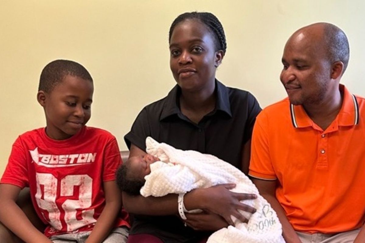 Mum Patricia, centre and holding Louisa, with brother Leshem, left, and dad Moses, right