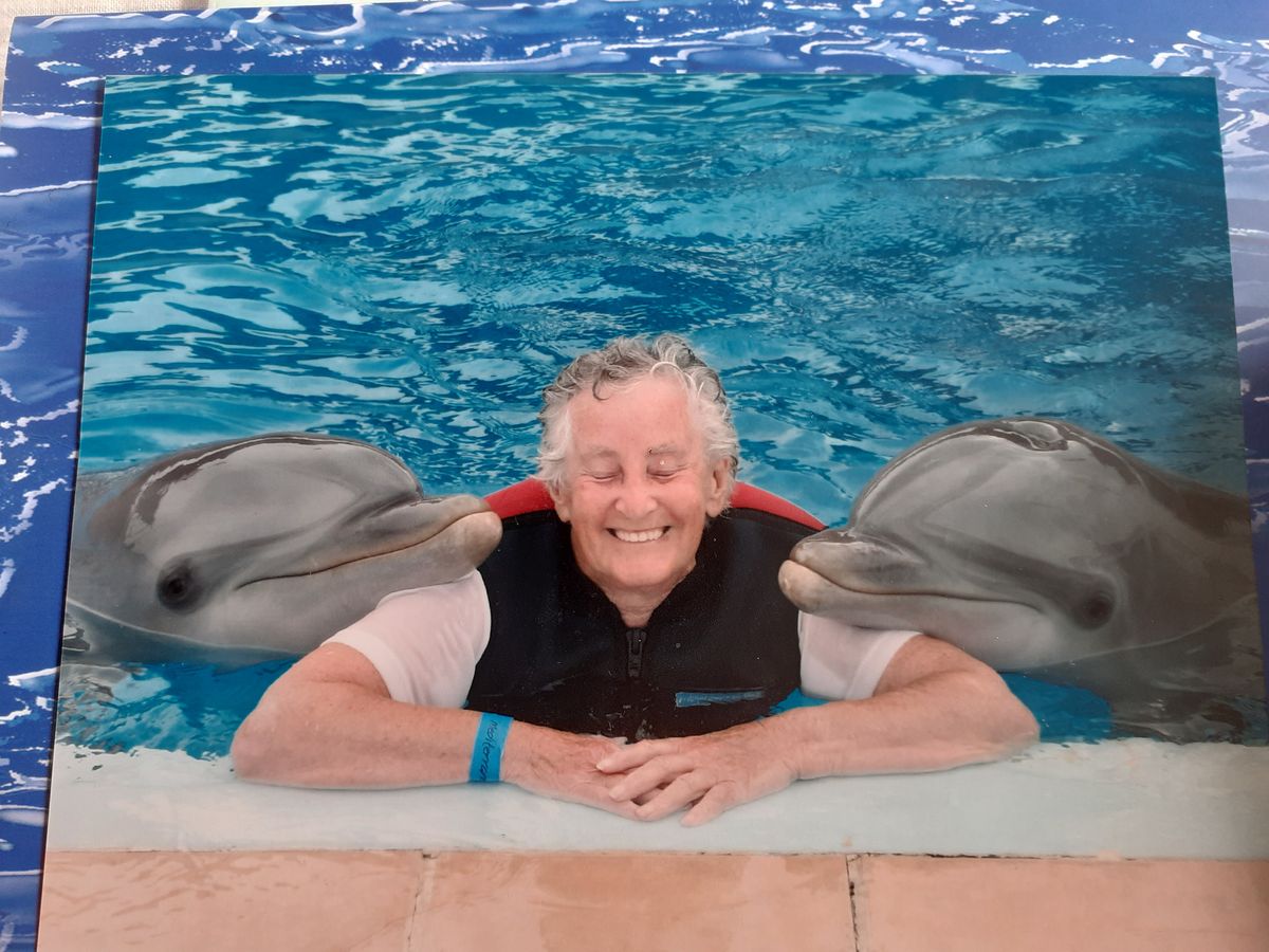 Joyce in a pool on holiday with dolphins 