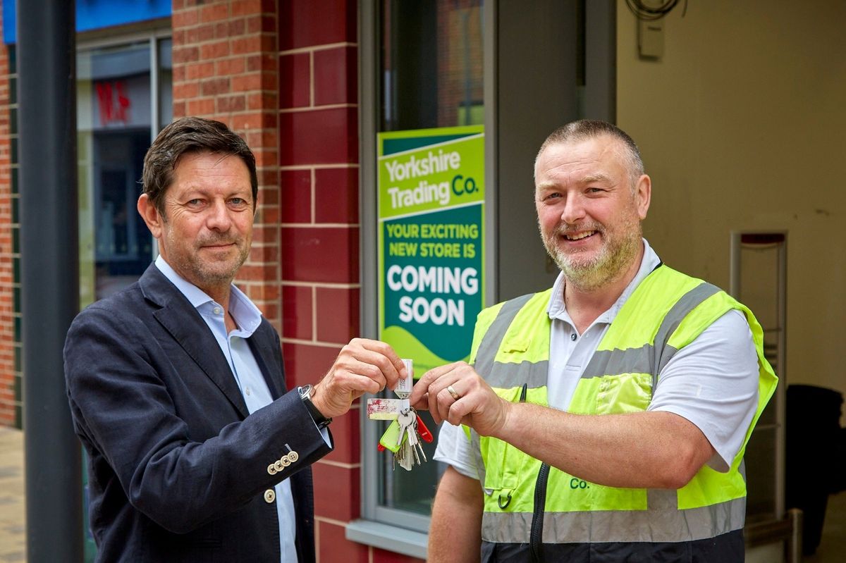 Jason Platten, left, head of retail and leisure at Wykeland Group, Flemingate’s owner and operator, hands over the keys to the store unit to Mark Johnson, operations and compliance manager at Yorkshire Trading Company